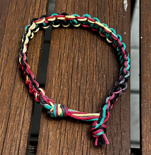 A wish bracelet with its ends trimmed