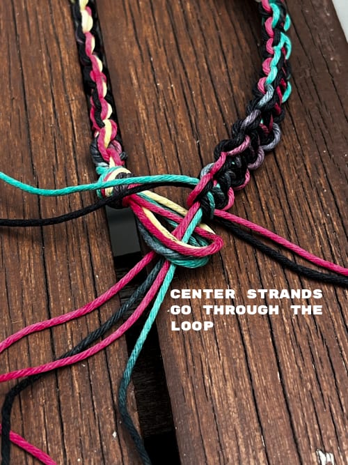 A wish bracelet untied and ungathered, showing the individual strands